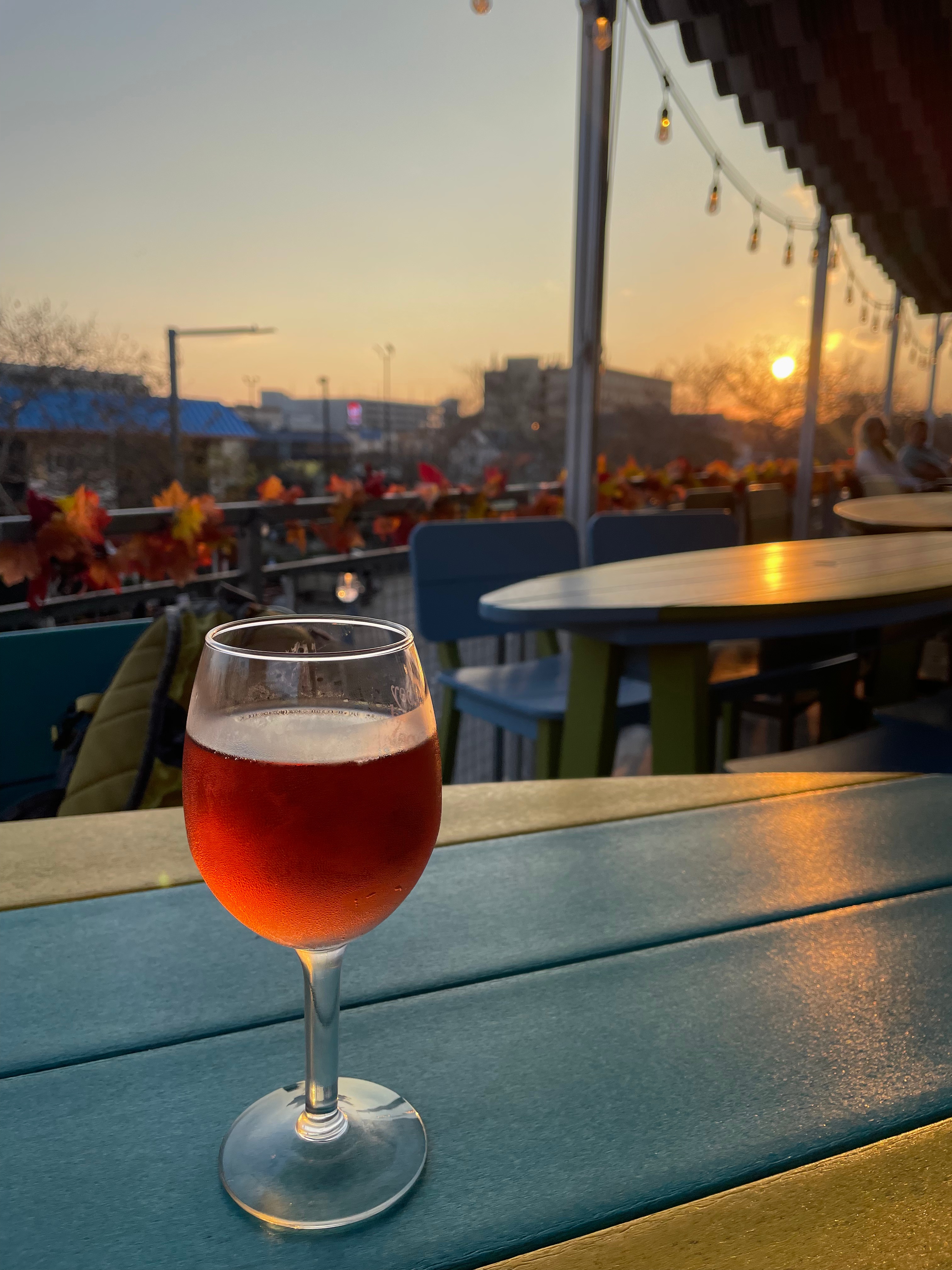 A glass of rose and a sunset view at Lucy's Sky Bar in Virginia Beach